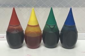 Bottles of red, yellow, green and blue artificial food colouring