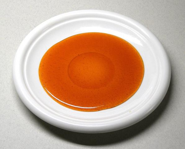 Sugar cooked to an amber caramel on a plate