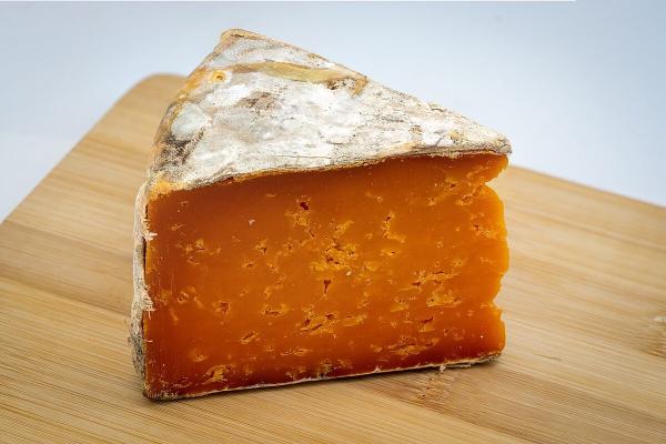 A wedge of mature cheddar cheese