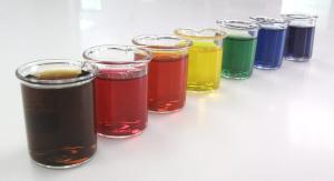 Beakers of food colourings in a rainbow of shades