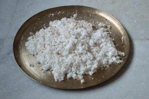 Freshly grated coconut on a brass plate