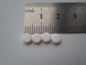 Saccharin and cyclamate sweetener tablets beside a ruler