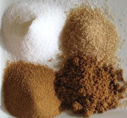 White, brown and unrefined sugars side by side