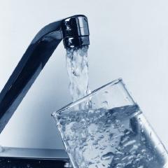 Water running from a tap into a glass