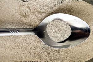 Granules of active dry baker's yeast on a spoon